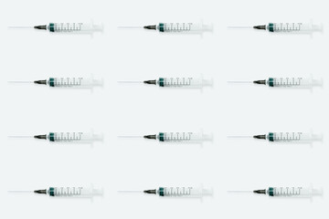 Seamless pattern with medical syringe and needle on light background
