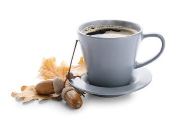 Cup of coffee with acorns and autumn leaves on white background