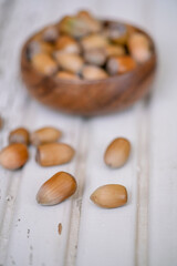 hazelnuts in a bowl on a wooden table with selective focus