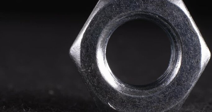 Screw close-up on a dark background. Fastener full face.