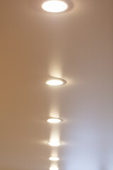 White light bulbs on a stretch ceiling