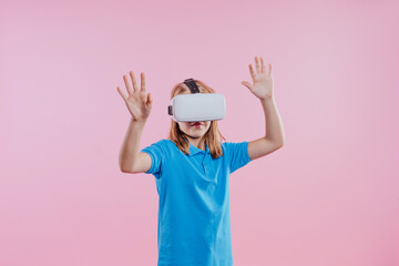 Teenager girl wearing virtual reality device on pink background