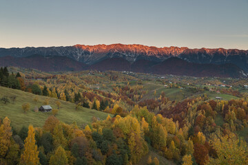 Fototapeta na wymiar Mountain rural landscape with autumn colors In Brasov county, Romania