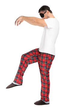 Man with eye mask in sleepwalking state on white background
