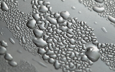 Macro background with water droplets condensation pattern on metal surface 
