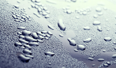 Macro background with water droplets condensation pattern on metal surface 