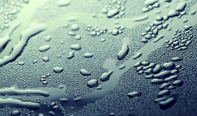Macro background with water droplets condensation pattern on metal surface 
