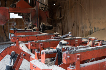 Old equipment for processing and cutting wood at a sawmill.