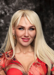 Obraz premium Portrait of beautiful young woman with long curly blonde hair 