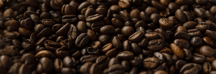 Roasted coffee beans. Top view on golden, aromatic beans. Natural background.