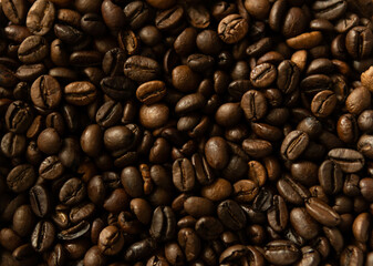 Roasted coffee beans. Top view on golden, aromatic beans. Natural background.