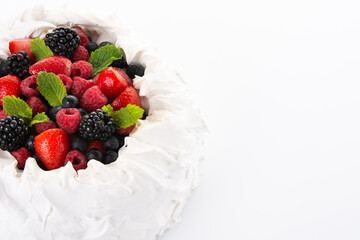 Delicious Pavlova cake with meringue topped and fresh berries isolated on white background