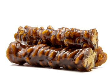 Sausage walnuts on a white background. Turkish walnut raisin sausage sweet. A sweet snack made by drying molasses and walnuts. local name ceviz sucuk