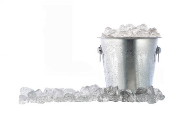 Full metal bucket with ice cubes and pieces of crushed ice isolated on white background. - obrazy, fototapety, plakaty
