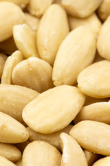 Fototapeta na wymiar Close-up Peeled almond kernel. food background. Snack Fresh Nuts. Story format