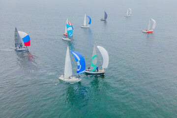 Aerial bird's eye view photo taken by drone of sailboat in turquoise sea water
