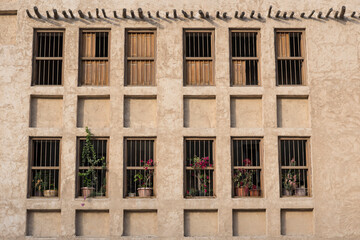 Doha,Qatar,05,10,2019. Old wooden windows in Arabic style on a traditional mud building in the market Souk Waqif.
