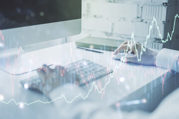 Multi exposure of abstract creative financial chart with hand typing on computer keyboard on...