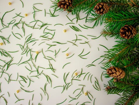 Christmas background with Christmas-tree branches, needles, cones. Getting ready for the holidays. Top view with copy space. DIY Christmas background for congratulations © evgeniia_1010