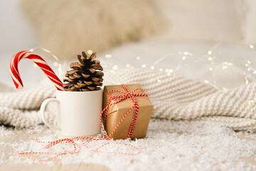 Merry Christmas. Ready Christmas card. Christmas gifts, sweet candy and cup with sparkler. Christmas background with garlands and New Year decorations.
