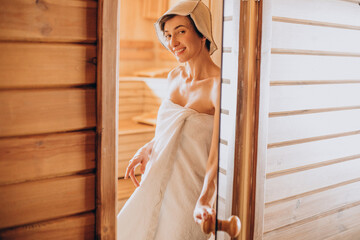 Woman resting in sauna and taking care of her skin