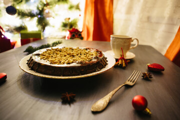 Cottages and gingerbread cookies on the Christmas table Gluten free christmas nut cake on a gray table with christmas decorations