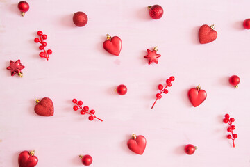 wooden carved Christmas decorations for the holiday tree on a pink background