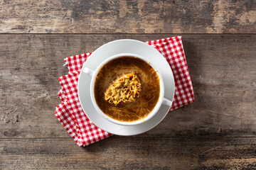 Traditional french onion soup on wooden table	