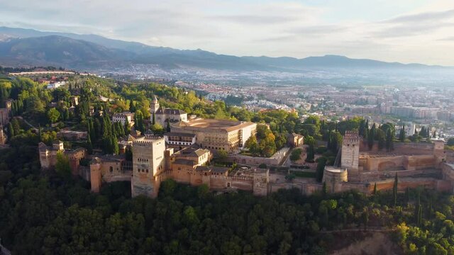 The medieval complex of Alhambra. Flying around Granada at sunrise, Spain, UHD, 4K