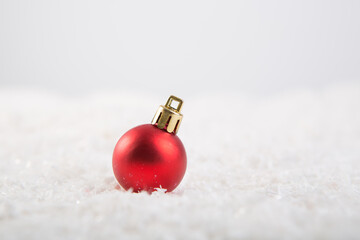Christmas ball on snow over white background