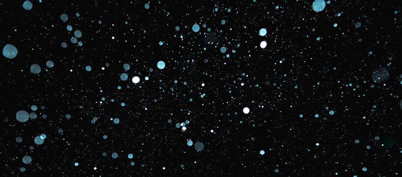 Blurred snowflakes on a dark background. Overlay image for snowfall effect