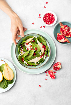 Spinach and pear salad with goat cheese and pomegranate seeds