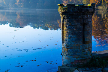 Stone turret by a mirror lake