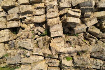 Naklejka premium Flying over the large open warehouse of straw bales on an industrial scale. Ukraine