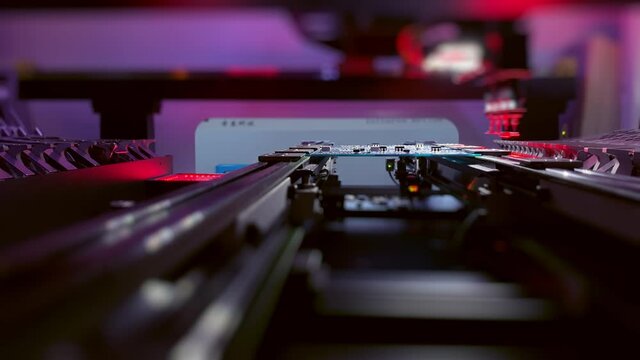 Automatic CNC machine operation: Assemble of system board elements by robotic hand. Technology for the precise installation of semiconductors and electronic components for the production of chips.