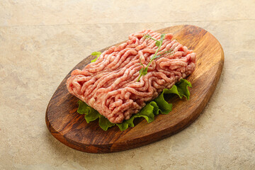 Raw minced pork meat over board