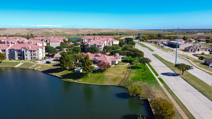 Aerial view waterfront new apartment complex near highway with DFW landfill community waste disposal background