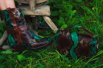 Leather boots and a bag in the same style, blurred background