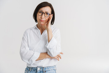 Frowning mature white woman in white shirt