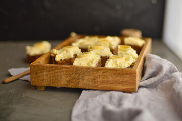 Tasty cake with banana with cream in wooden box. cheesecake on the table. sweet toffee cake.