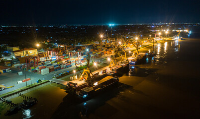 Obraz premium Container ship in export and import business and logistics. at Cambodia . Water transport International. Aerial view