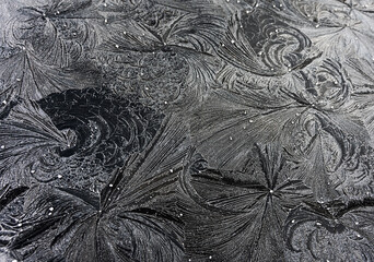 abstract ice patterns on black metal
