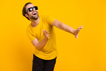 Naklejka premium Photo of young cheerful man have fun dancing wear casual outfit isolated over yellow color background