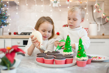 Brother and sister making cupcakes