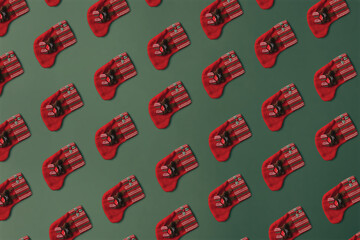 Christmas pattern with red xMas socks against dark green background.Minimal layout.