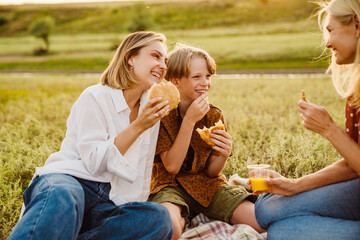 White family laughing together during picnic on field