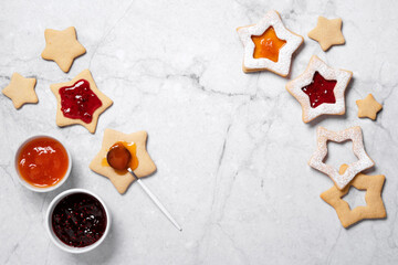 Traditional Linzer cookies with red and yellow jam. Cooking Christmas background