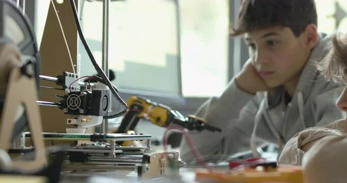 Students using a 3D printer in the lab