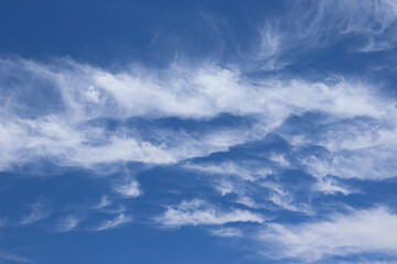 Fototapeta premium White clouds against blue sky, during a bright Summer day.