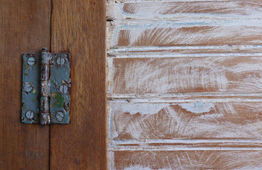 Close up of rusty hinge on handmade wardrobe's door.